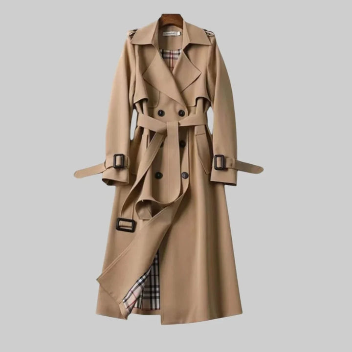 Women's beige double-breasted trench coat with belted waist and plaid lining