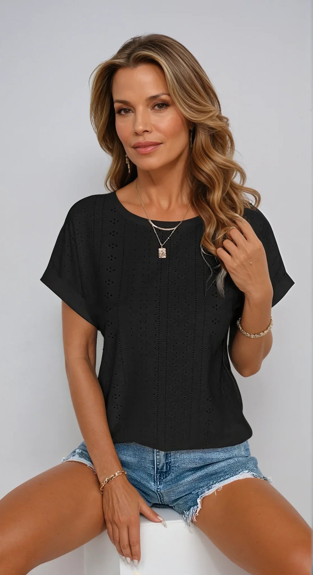 Women's eyelet short-sleeve top with crew-neck and cuffed sleeves