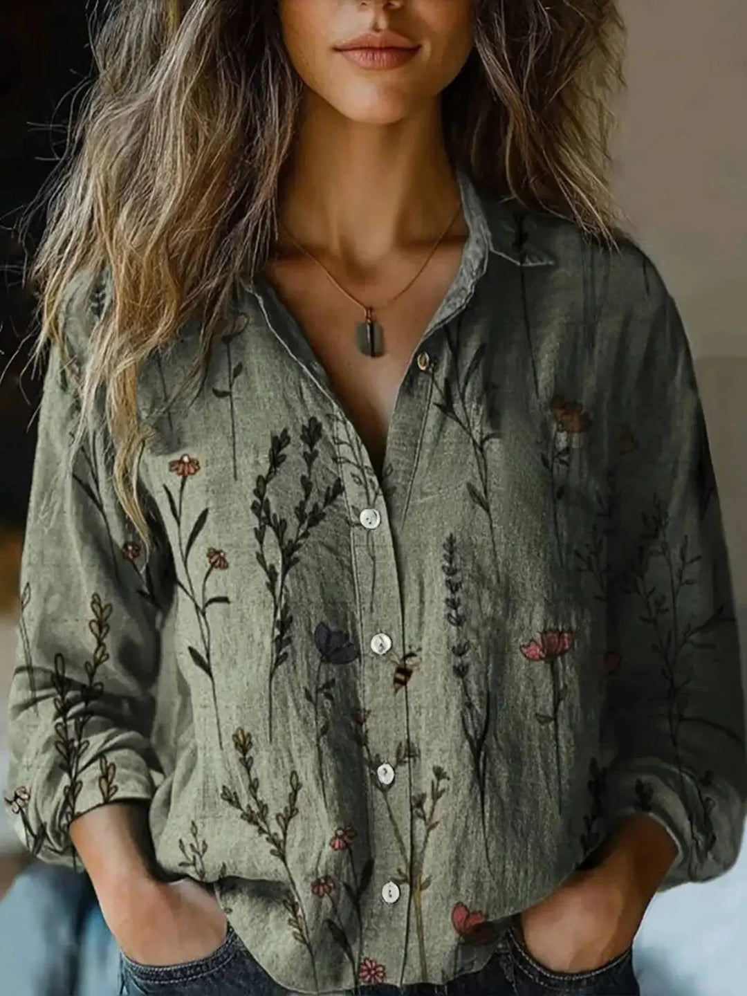 Women's floral collared button-down shirt with long sleeves and chest pockets
